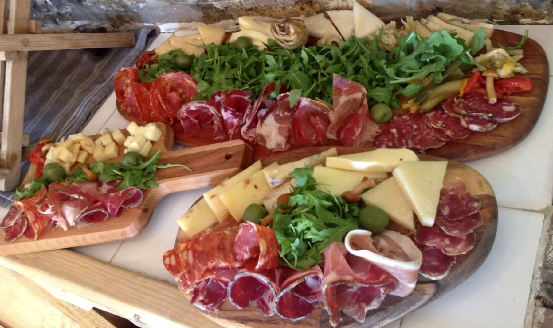 Antipasto boards with cured meats, cheeses and rocket