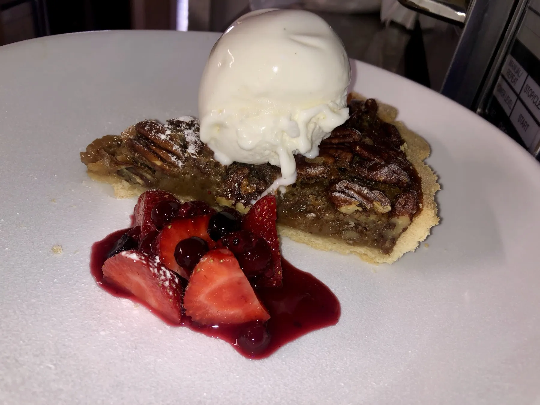 Pecan tart with vanilla ice cream and berries