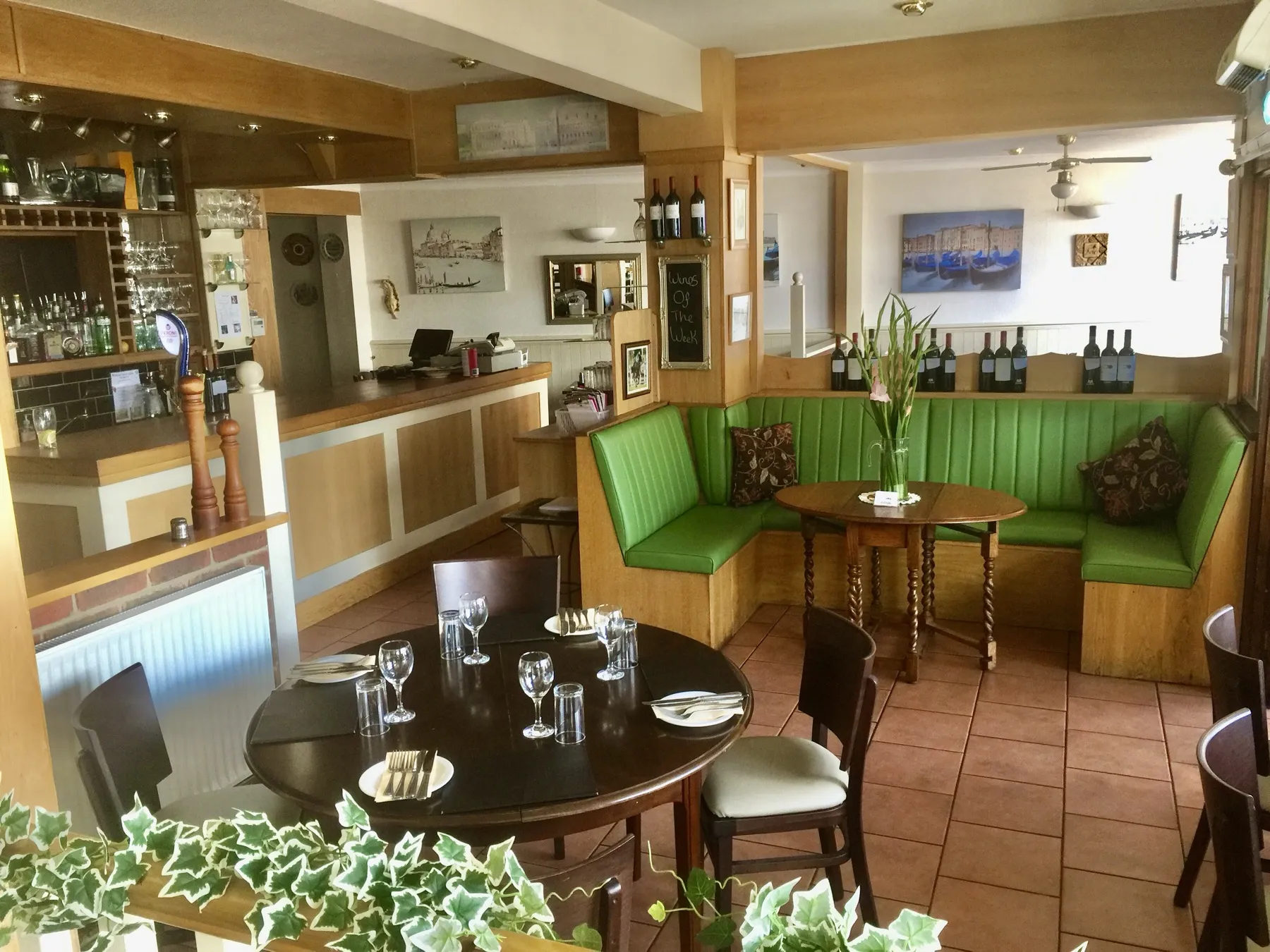 The green banquette seating and bar inside Nicolino's