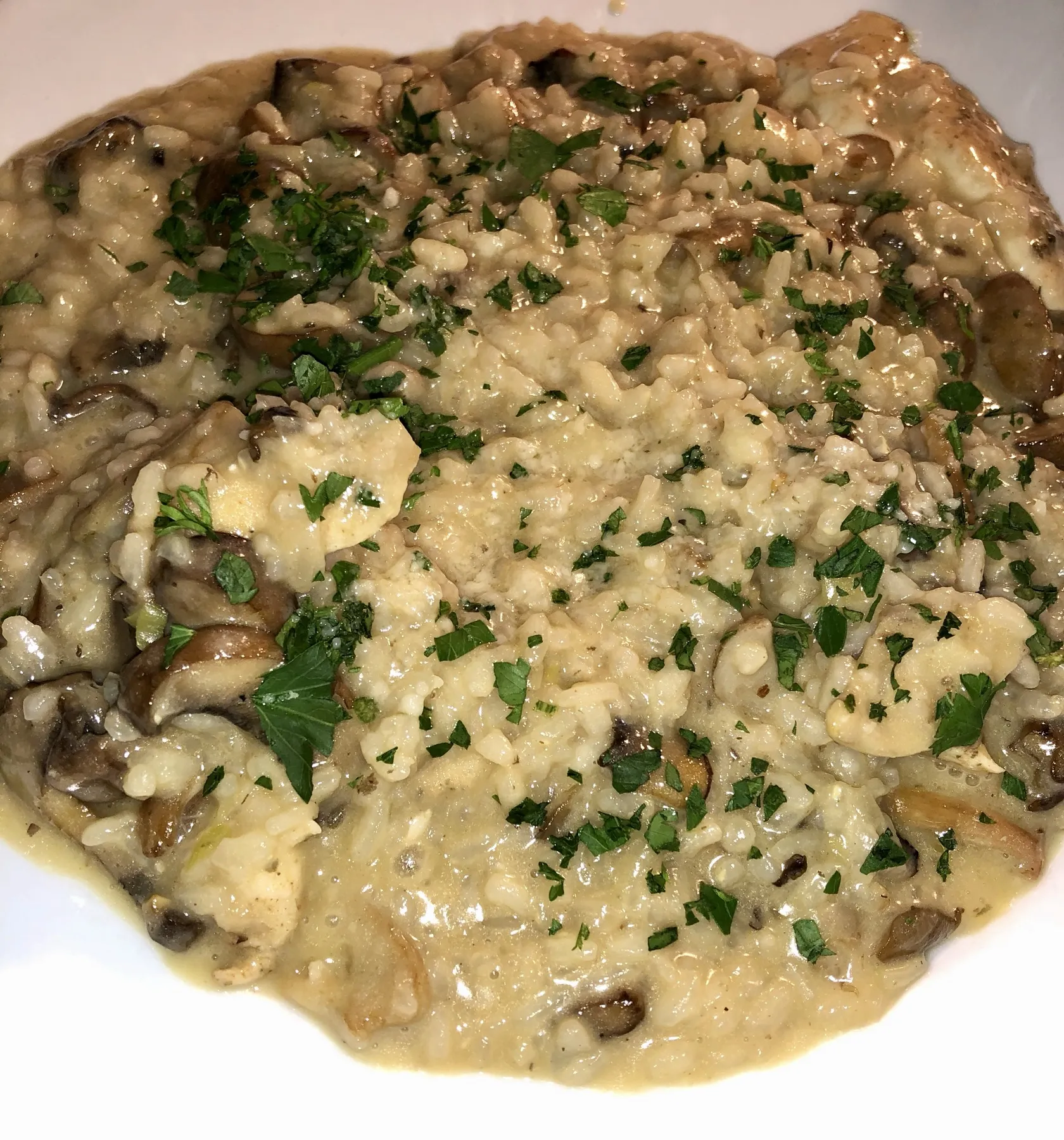 Mushroom risotto finished with parsley and parmesan